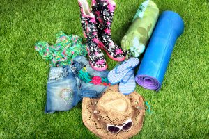 "Flipflops, wellies, bed roll, sunglasses etc for camping at a music festival"